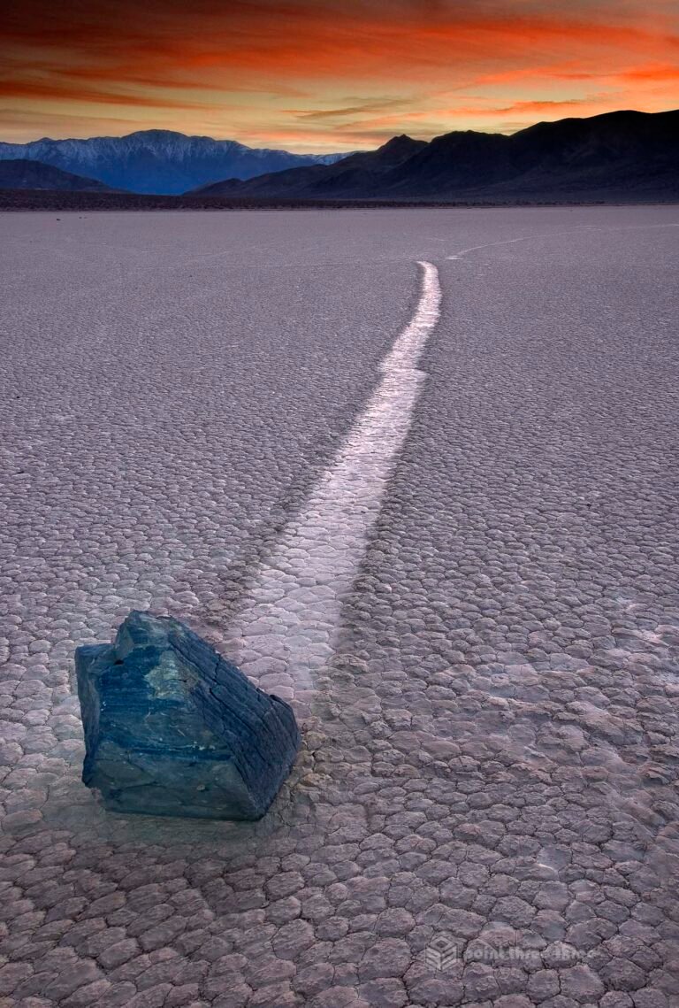 Sunset at The Racetrack in Death Valley National Park with light painted boulder