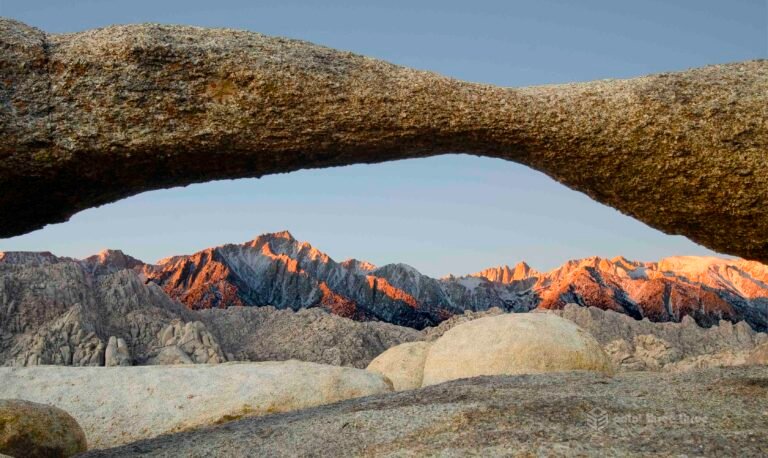 Sunrise at Lathe Arch with Mount Whitney in background in Alabama Hills, California