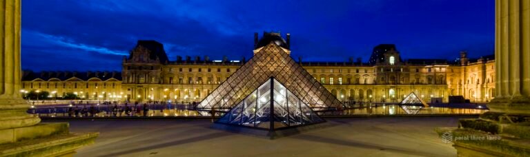Sunset at Louvre Museum lit up in Paris France