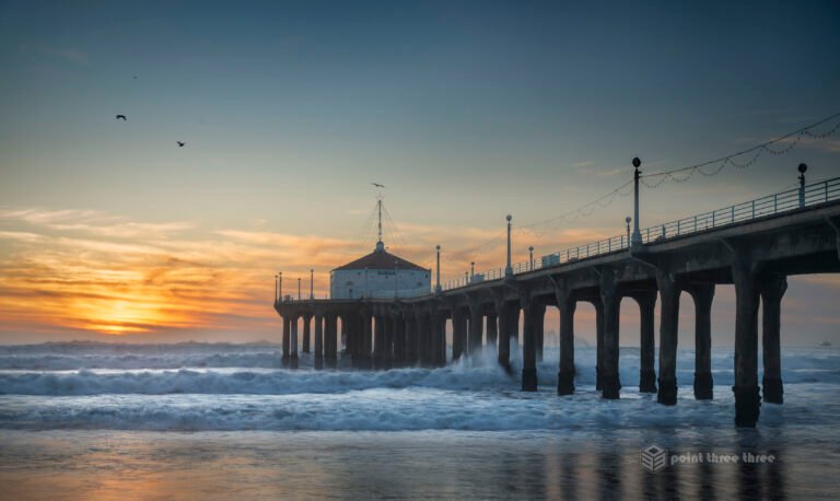 Sunset and crashing waves at Manhattan Beach Pier, Los Angeles, California