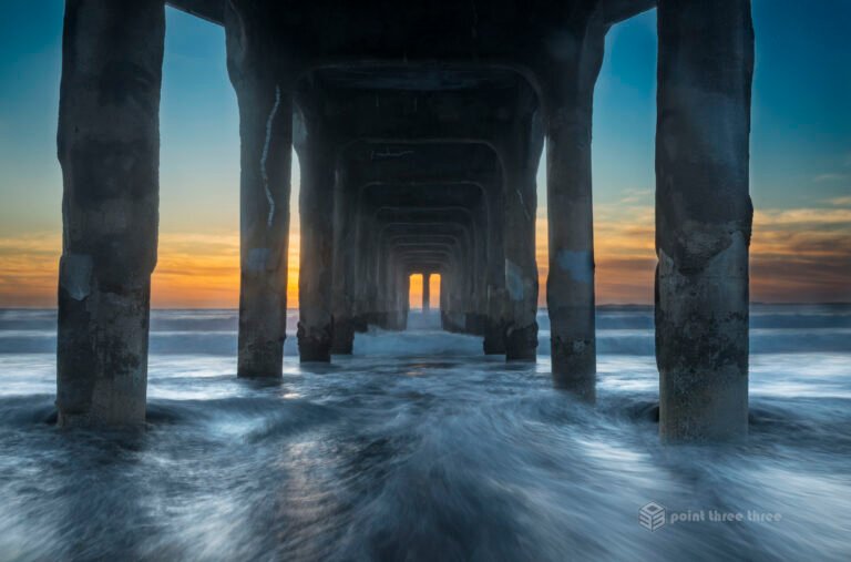Sunset and rushing waves at Manhattan Beach Pier, California