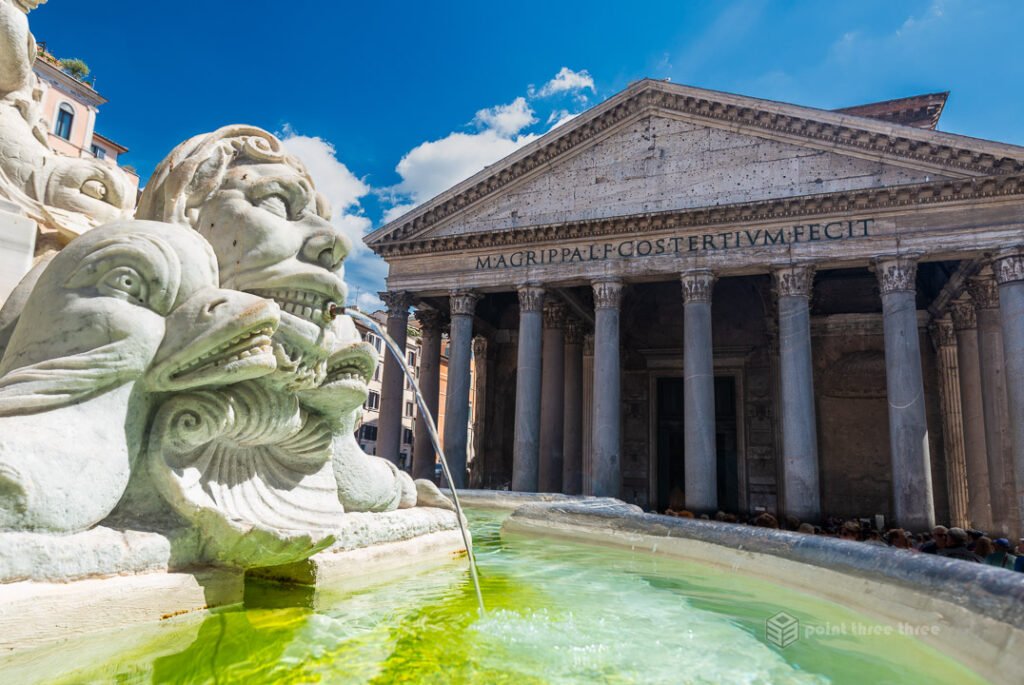 The exterior of the Roman Pantheon showing the ancient Corinthian columns and the fountain in Piazza della Rotonda.