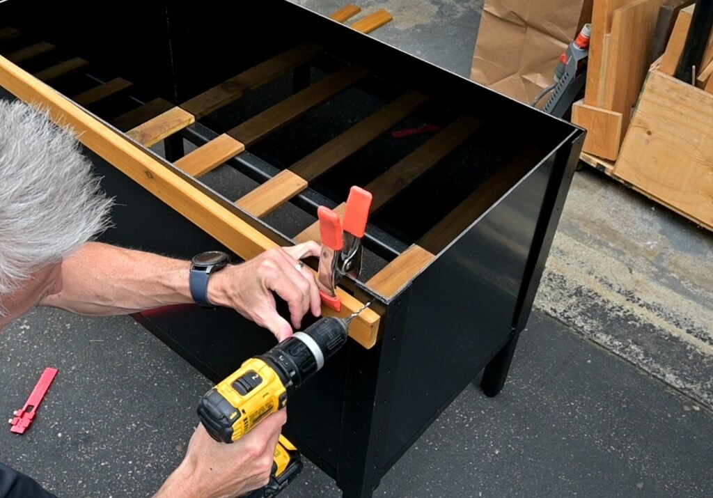 Drilling holes for the ACM which will be guides for the screws