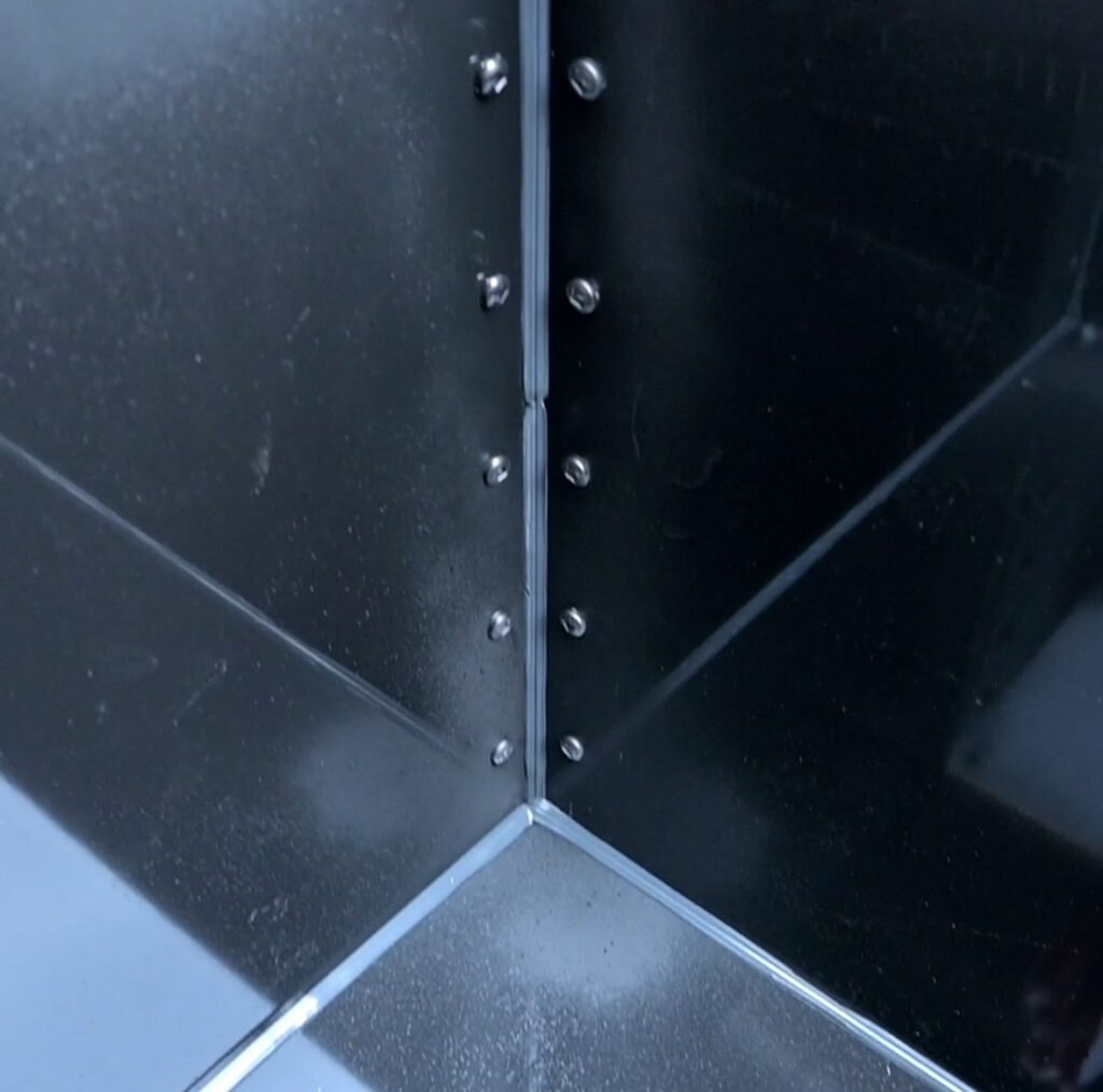 Sealed adhesive corners for ACM